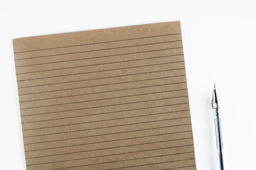 Notebook sheet in a ruler. School notebook. Lines. Brown paper. Close-up notepad sheet. Secondary use. Copy space