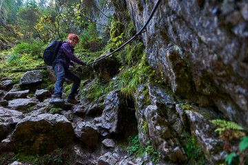 Tourist woman hiking in the mountains