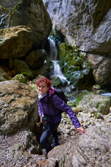 Naklejka na ściany i meble Tourist woman hiking in the mountains