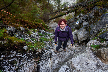 Naklejka na ściany i meble Tourist woman hiking in the mountains
