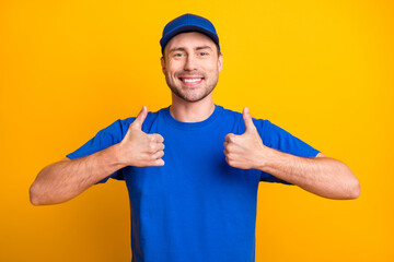 Portrait of cheerful handsome guy show two hands thumbs up toothy smile isolated on yellow color background