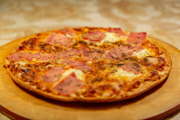 Textured surface of cheese pizza with spices. Homemade fresh baking recipe