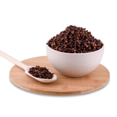 Freshly dryed clove spice in white ceramic bowl on wood board isolated on white background, copy space.