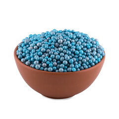 Blue sugar dragee in white bowl isolated on white background, copy space.