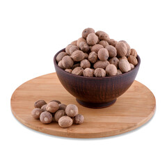 Whole nutmeg spice in brown bowl on wood board isolated on white background,copy space.