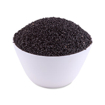 Black cumin seeds in white bowl isolated on white background; copy space.