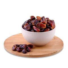 Dried date fruits in white bowl on wood board isolated on white background, copy space.