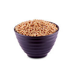 Golden sugar dragee in white bowl isolated on white background, copy space.