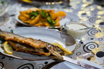 Fototapeta na wymiar Close up of fish kebab or grilled fish on charcoal skewer on plate