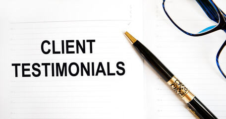 In the diary, the text CLIENT TESTIMONIALS, next to the pen, glasses.