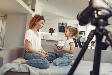 Cute little beauty blogger. Girl speaking in front of camera for vlog.