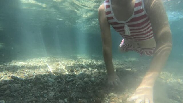 A girl practicing diving in a hot pool in Mae Hong Son, Thailand.