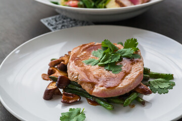 Plates with food in restaurant. Steak and mushrooms , tasty fresh food ready for hungry customer. Beef sliced minion