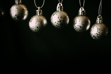 Fototapeta na wymiar Collection of silver christmas balls on black background with copy space. 