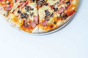 Freshly baked large pizza with ham, mushrooms and mozzarella on a traditional dough