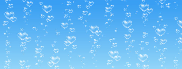 Heart shaped bubbles in water on blue background