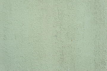 green old texture of plaster on the wall of a street house