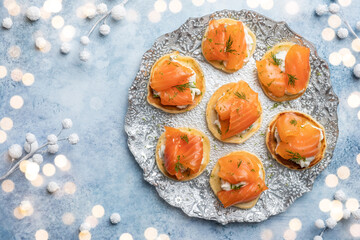 Blini with smoked salmon and sour cream, garnished with dill