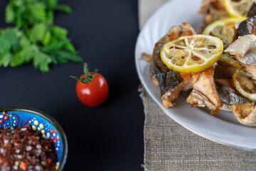 fried fish with herbs and lemon