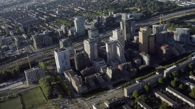 Aerial view of Amsterdam Financial Mile. The Zuidas in on a sunny day. Netherlands financial district with many buildings. It is located between the Amstel river and the A10 ringway.