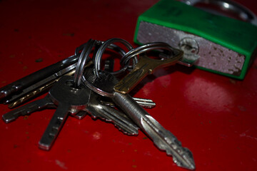 Lock with keys on a red old safe.
