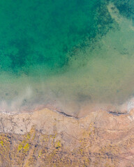 Bokod, Hungary - Aerial drone view of cooling lake coastline near Bokod power plant. Crystal clear turquoise water.