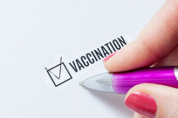 Vaccination is a positive answer in the questionnaire. The hand of a young woman fills the...