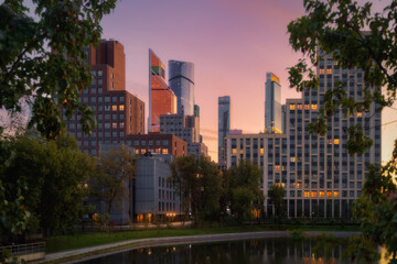 Fototapeta na wymiar Moscow city in Russia at dramatic sunset. Park Krasnogvardeyskiye Prudy (pond Krasnogvardeyskiy)