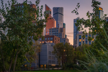 Moscow city in Russia at dramatic sunset. Park Krasnogvardeyskiye Prudy (pond Krasnogvardeyskiy)