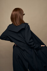 Attractive woman stylish clothes self-confidence rejoicing on a beige background 