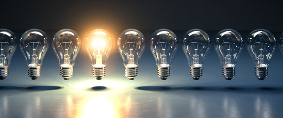 A row of lightbulbs with one brigthly lit - concept for having an idea, innovation, standing out....