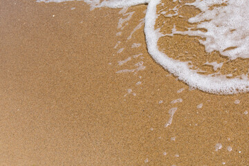 Sandy beach with a sea wave and a place for an inscription.