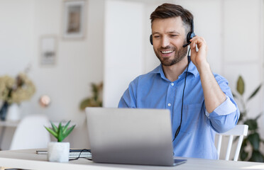Hotline Operator. Handsome Man Customer Support Manager In Headset Consulting Clients Online