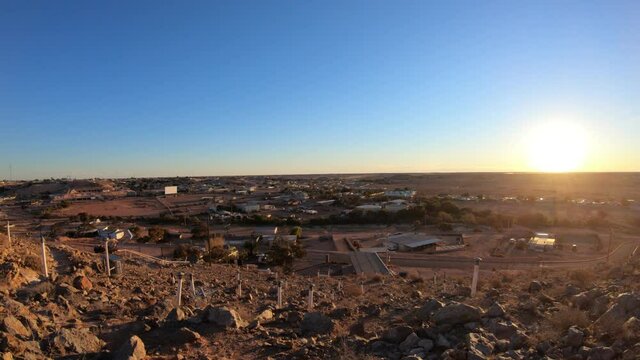 Aerial view of Coober Pedy skyline in Australian outback from lookout with main buildings of Coober Pedy city and underground town. Red desert of South Australia.