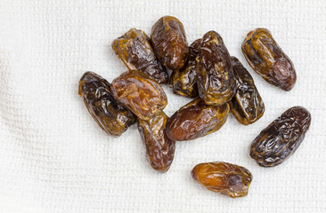Dried dates on white cloth - top view image