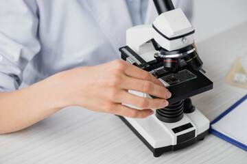 partial view of scientist using microscope in lab, stock image