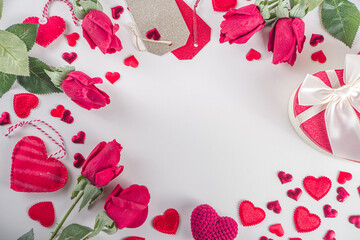 Valentine's Day background. Flat lay frame made with rose flowers, gifts, candles, confetti on white background. Valentines day greeting card concept. Top view, copy space.