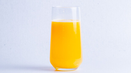 Healthy orange fresh juice in glass on a white background.