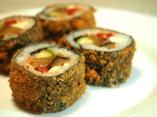 Sushi roll with mushrooms, tomatoes and cucumbers closeup