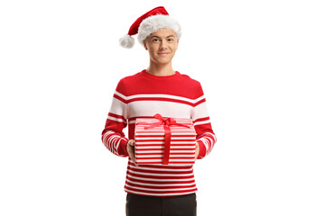 Guy in a sweater and a Santa Claus hat holding a present