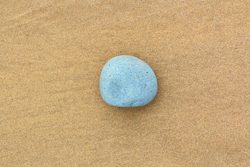 Fototapeta na wymiar Sandy beach with stones in a postcard like iconic style