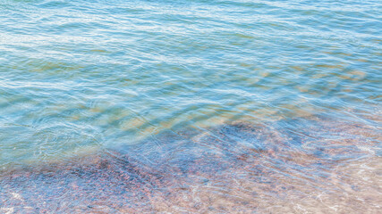 crystal clear azure water with sea foam, seascape background