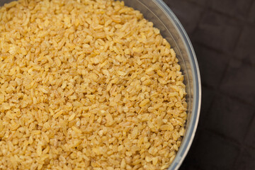 Close up bulgur grains background.