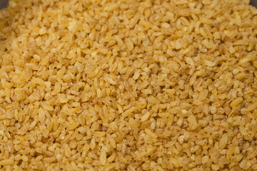 Close up bulgur grains background.