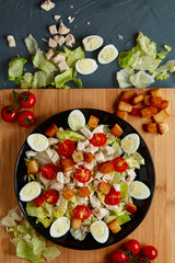 Caesar salad with the ingredients. Flat lay. On a tray.