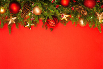 Fototapeta na wymiar Christmas background with copy space. Festively decorated spruce branches on a red banner. Flat lay style.