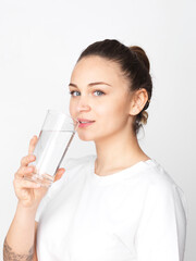 Young woman drinking a glass of clean water
