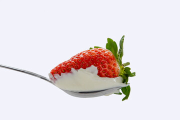 Strawberries in a spoonful of sour cream