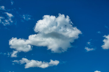 image of a blue sky with a few white clouds  