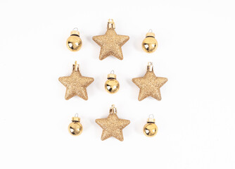 Top view of minimal golden and yellow Christmas elements, gold ball, stars glitter on white background